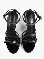 Architectural Bow Stilettos: Glossy Black Multi-Strap Heels for Modern Chic