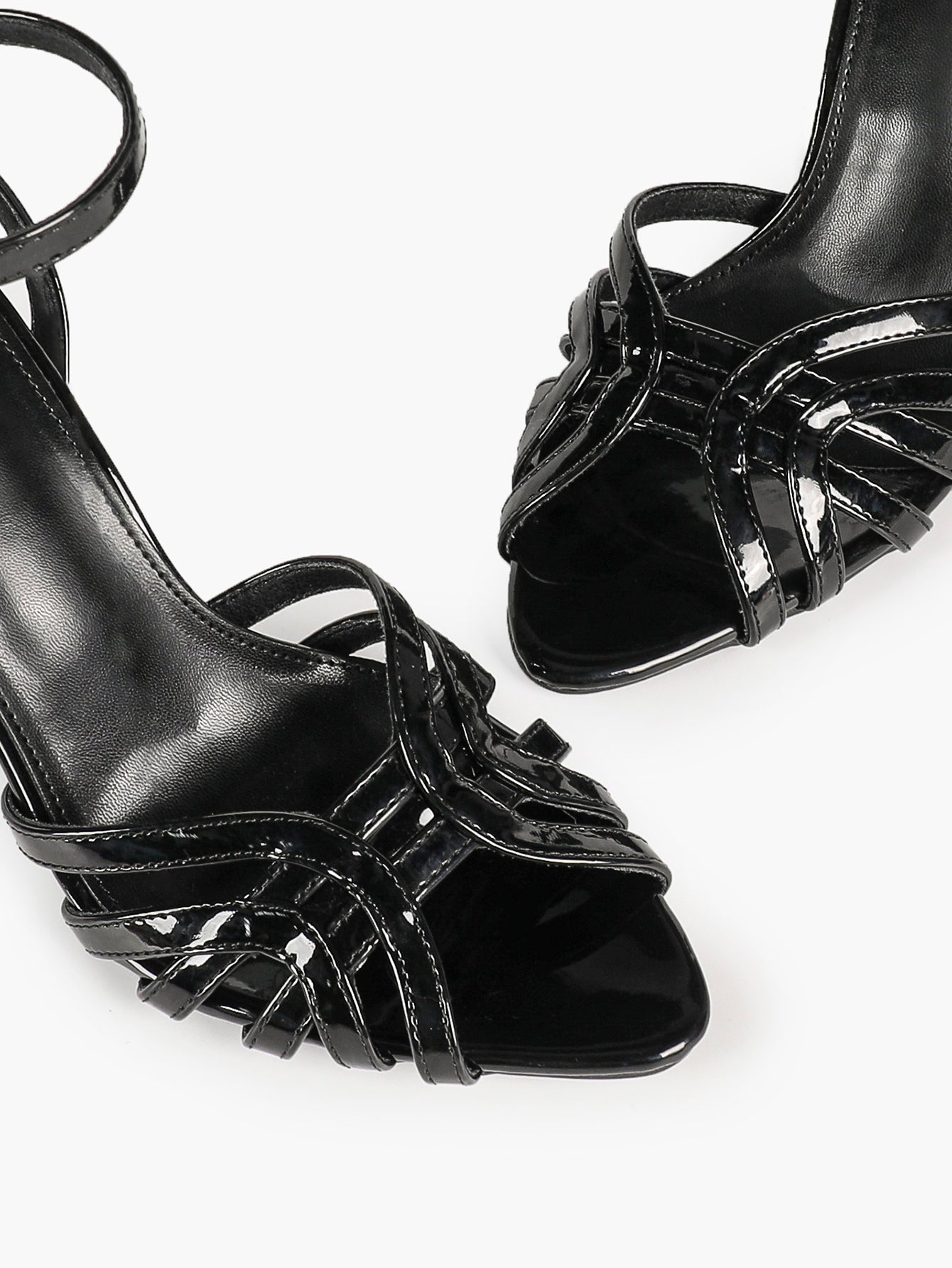 Urban Lattice: Black Patent Cage-Strap Stilettos for the Modern Power Woman