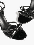 Architectural Bow Stilettos: Glossy Black Multi-Strap Heels for Modern Chic