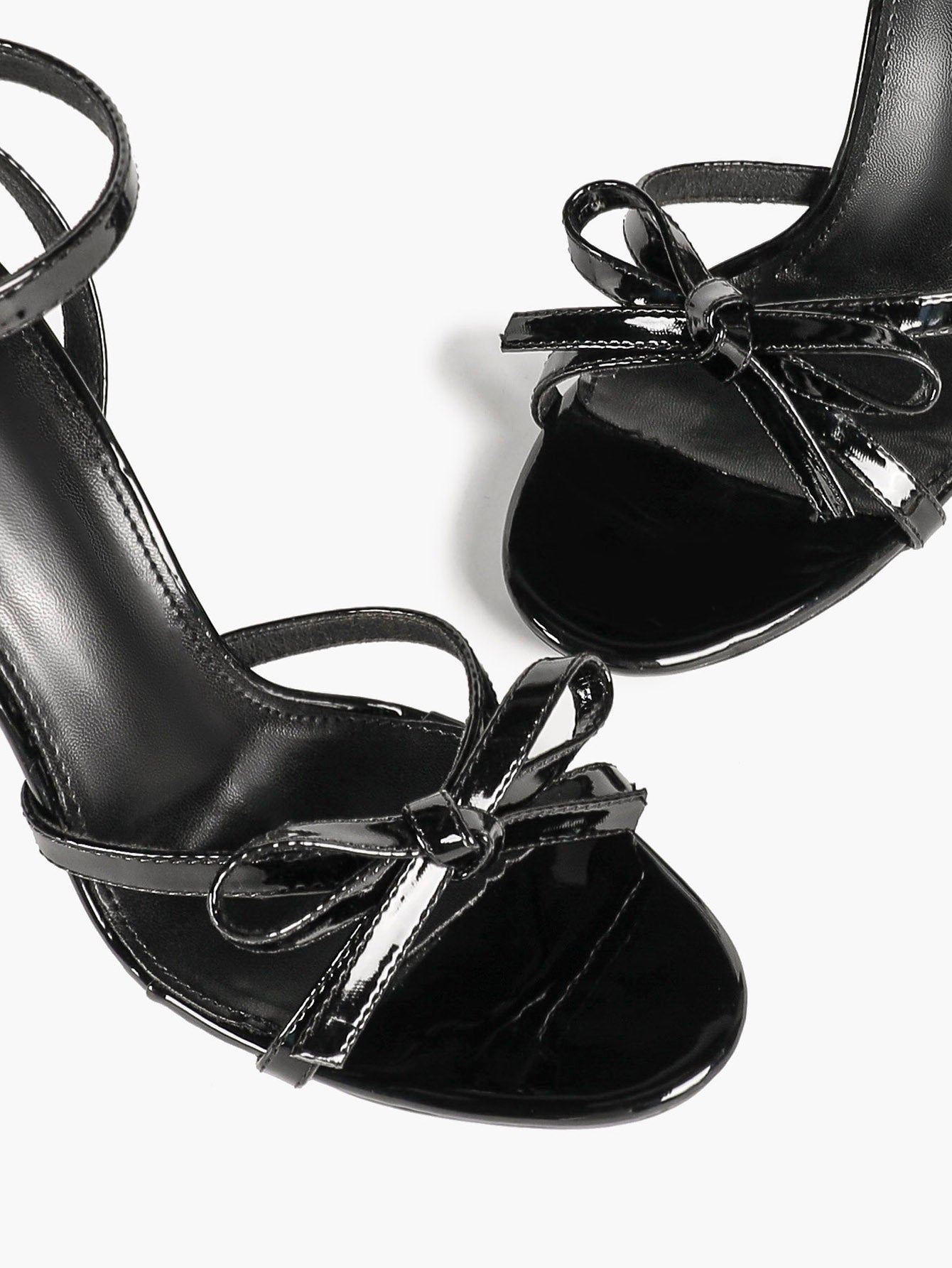 Architectural Bow Stilettos: Glossy Black Multi-Strap Heels for Modern Chic